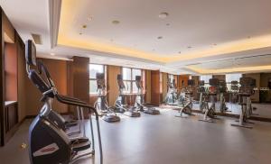 a gym with cardio equipment in a hotel room at Changzhou Yuanzhou Hotel in Changzhou