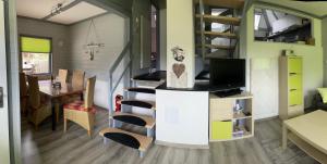 a tiny house with a staircase and a living room at All inclusive Ferienhaus JULYN , Seepark in Kirchheim