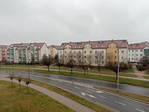 a city street with a row of apartment buildings at Apartament 24 in Płock