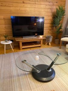 a glass table in a living room with a tv at Mer de Glace in Chamonix-Mont-Blanc