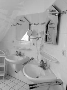 a white bathroom with a sink and a mirror at Baltique in Glowe