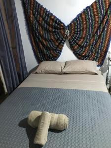 a bed with a pair of mitts on it at Casinha da Estrela in Arraiolos