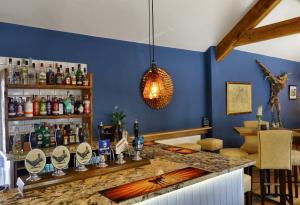 a bar in a restaurant with a blue wall at The Pickled Pheasant in Holmfirth