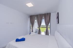 a white room with a large window and a bed at Al-1103 Estepona - Apartment - Alcazaba Lagoon in Estepona +40 photos