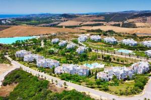 an aerial view of an apartment complex with a road at Al-1103 Estepona - Apartment - Alcazaba Lagoon in Estepona