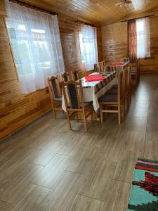 a dining room with a table and chairs in a cabin at Cabana Elena in Gîrda de Sus +21 photos