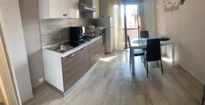 a kitchen with a sink and a table at New zarà in Villa San Giovanni