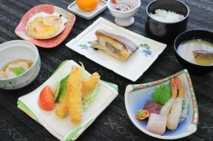 a group of plates of food on a table at Hotel Saharin in Wakkanai