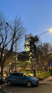 a blue car driving down a street with a building in the background at ACADAMIS - Loft dei Principini in Turin