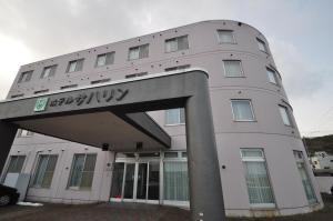 
a large building with a large clock on the front of it at Hotel Saharin in Wakkanai
