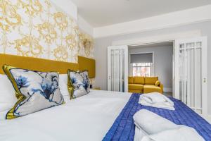 a bedroom with a large bed with a blue blanket at Ashbys Accommodation & Spa hire in Portsmouth