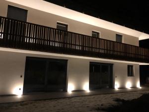 a building with lights on the side of it at night at Villa Lara Zirbe in Castelrotto