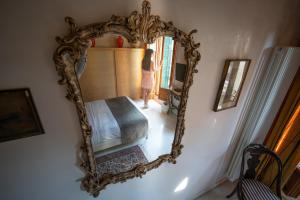 a woman standing in front of a mirror at Palazzo San Luca in Venice