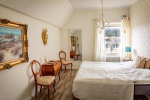 a bedroom with a bed and a table and chairs at Sweet Dreams B&B Ullared in Ullared