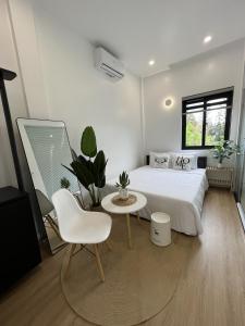 a bedroom with a bed and a table and a chair at ANH’s HOUSE in Hue