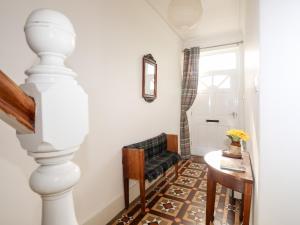 a living room with a table and a chair at Gwynant - Morfa Nefyn in Pwllheli +38 photos