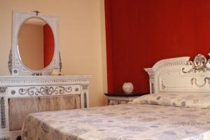 a bedroom with a white bed and a mirror at Il Fosso in Borghetto Santo Spirito