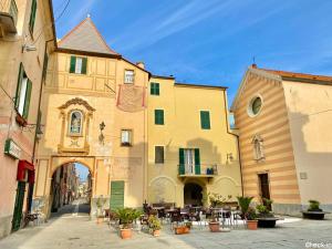 a group of buildings with tables and chairs in a street at Il Fosso in Borghetto Santo Spirito