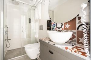 a bathroom with a sink and a toilet and a mirror at Pleasant Flat near Hadrians Gate in Antalya