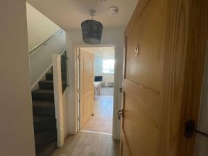 a hallway with a staircase and a door with a stair case at SUPER Duplex Central City Apt FREE PRIVATE parking in Plymouth