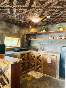 a kitchen with wooden cabinets and a sink at VILLA NEYRA 
