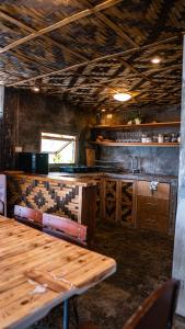a kitchen with a wooden table and a sink at VILLA NEYRA 