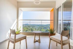 a room with a table and two chairs and a large window at THE TERRACE MANJERI in Manjeri