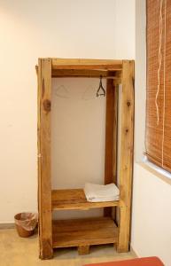 a wooden shelf in the corner of a room at Battaramulla Boutique Villa in Sri Jayewardenepura Kotte