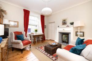 a living room with a couch and a fireplace at Charming Hideaway in Edinburgh City Centre in Edinburgh