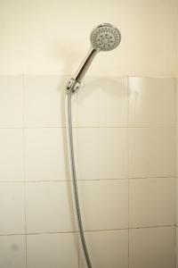 a shower with a shower head in a bathroom at Battaramulla Boutique Villa in Sri Jayewardenepura Kotte