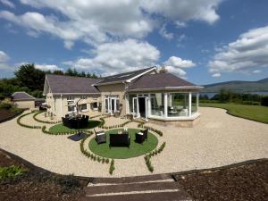 a house with a patio and a lawn at LakeviewLodge in Wicklow