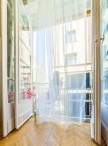a room with a large window with a chair in front of it at Real Apartments Wesselényi II. in Budapest
