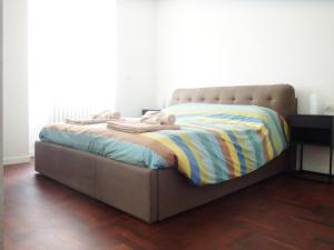 a bed with a blanket on it in a room at Casa Nina in Sondrio