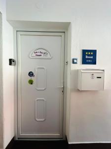 a white door with a sign on it in a room at Lu-Lu room in Požega