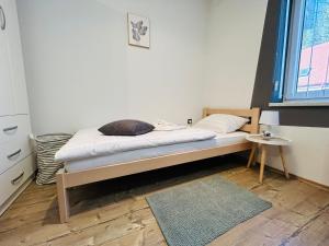 a bedroom with a bed with a rug and a window at Lu-Lu room in Požega
