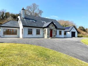a large white house with a driveway at Ballydonnellan in Westport