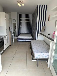 a room with two beds in a kitchen at RICCIO BLU pochi passi dal mare in Alba Adriatica