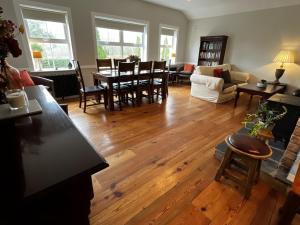 a living room with wooden floors and a table and chairs at Living Waters Retreat in Donegal