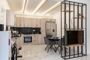 a kitchen with a table with a television in it at Athens Flat with Gym Equipment 3 minutes to Metro in Athens