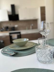 a table with a plate and a bowl and a glass at Südstrand nahe Eigentumswohnung mit Stil in Wilhelmshaven +13 photos