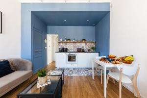 een blauwe woonkamer met een tafel en een keuken bij La Bonne Mère-Vue Notre-Dame de La Garde in Marseille