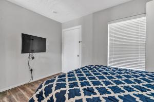 a bedroom with a bed and a flat screen tv at Reel Simple in Moneta