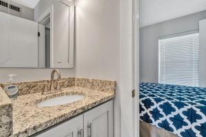 a bathroom with a sink and a bed at Reel Simple in Moneta
