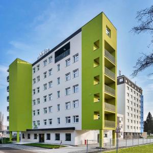 a green and white building on a street at Hotel Morava in Otrokovice