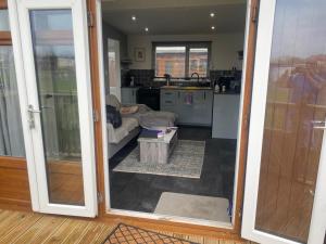 a living room with a door open to a kitchen at S and S Chalets Mablethorpe in Mablethorpe