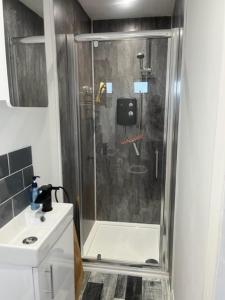 a shower with a glass door in a bathroom at S and S Chalets Mablethorpe in Mablethorpe