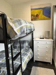 a bedroom with a bunk bed and a night stand at S and S Chalets Mablethorpe in Mablethorpe