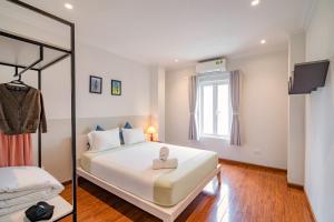 a bedroom with a large white bed and a window at WECOZY HANOI - Railway Side, The Old Quarter in Hanoi