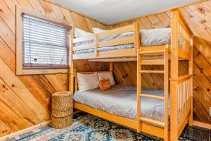 a bedroom with bunk beds in a log cabin at A-Frame of Mind in Beech Mountain