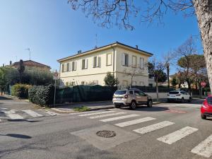 a car parked on a street in front of a building at Villa Sante Residence in Pesaro +26 photos